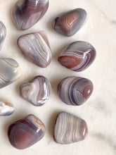 Load image into Gallery viewer, banded botswana agate group close up
